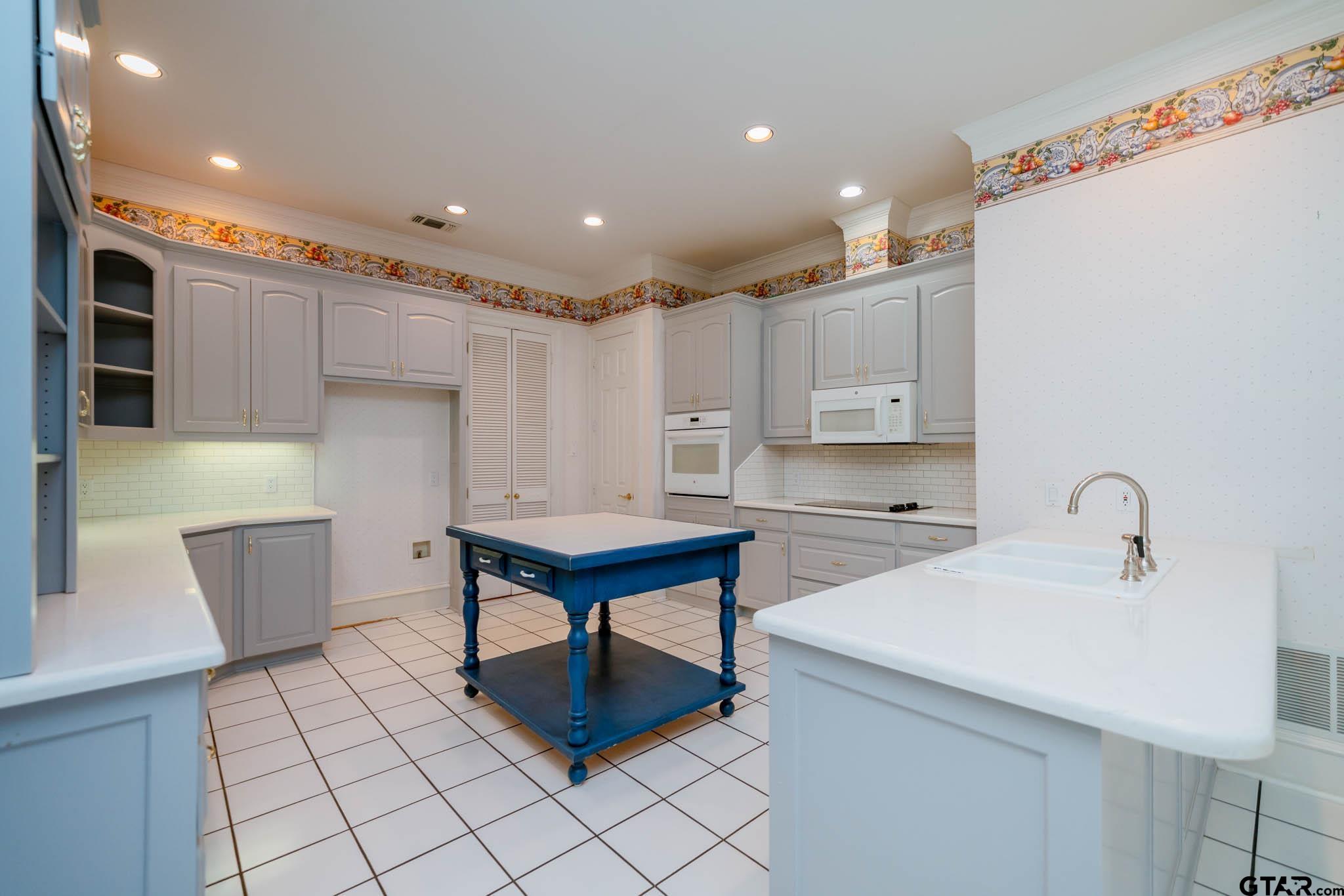 7 Summer Creek Way Longview, TX 75604 - Photo 12 of 48 a kitchen with a sink cabinets and wooden floor