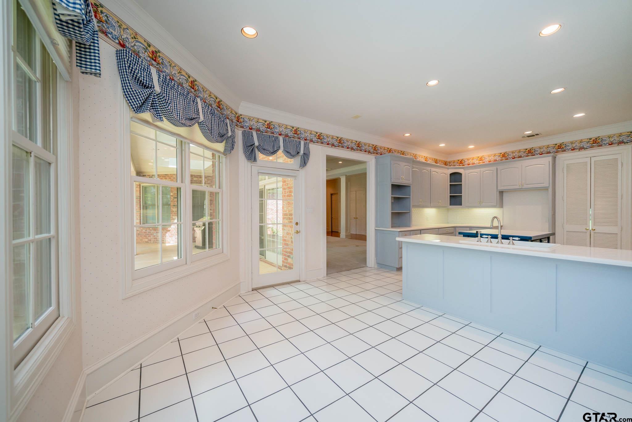 7 Summer Creek Way Longview, TX 75604 - Photo 13 of 48 a large white kitchen with a sink and cabinets