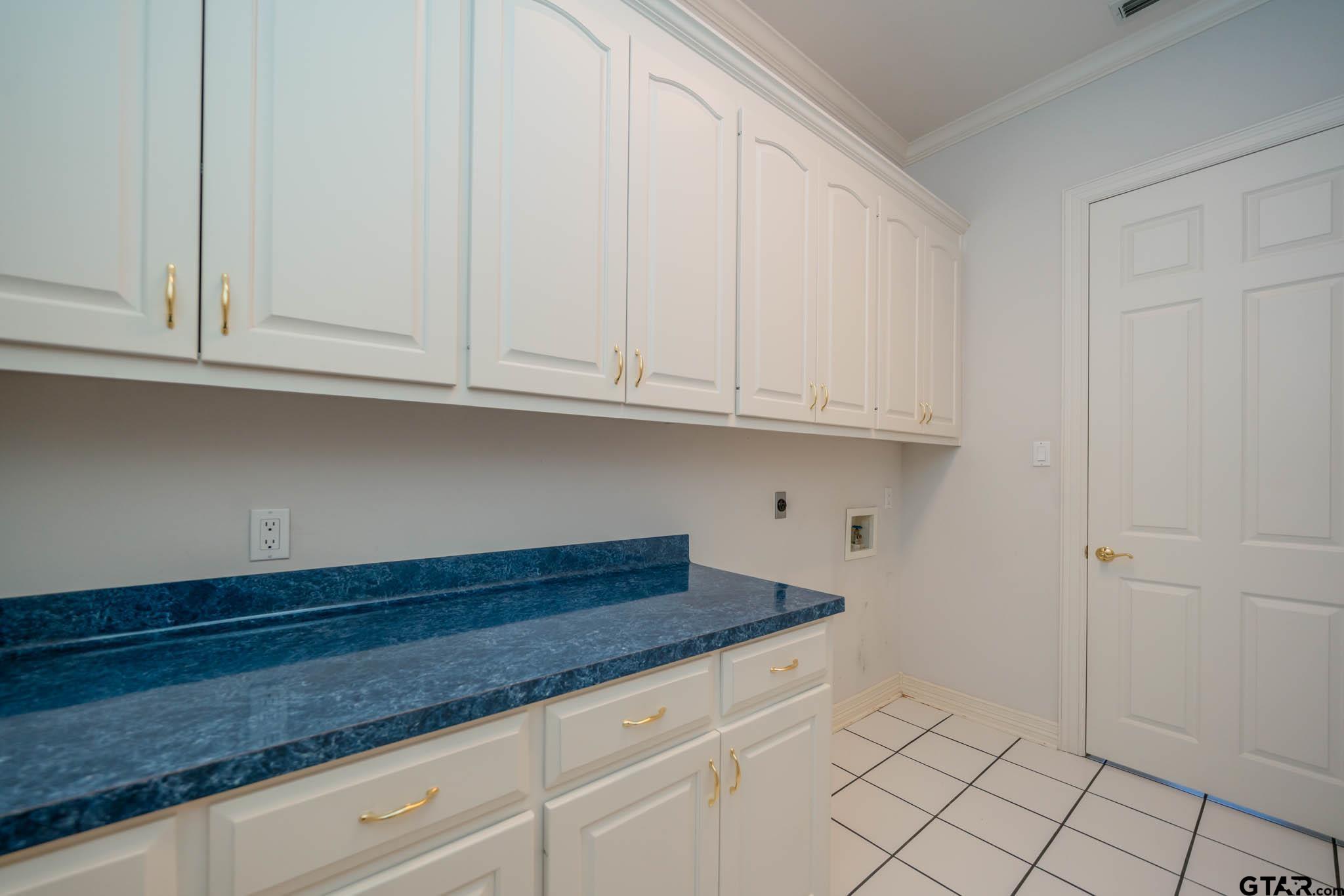 7 Summer Creek Way Longview, TX 75604 - Photo 16 of 48 a kitchen with granite countertop white cabinets and a white wooden floor