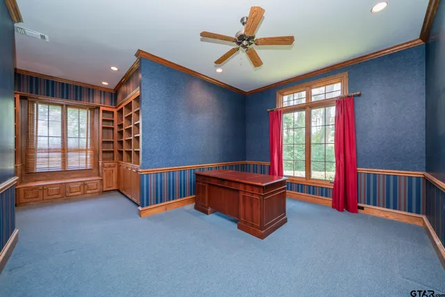 a living room with furniture gym equipment and a window