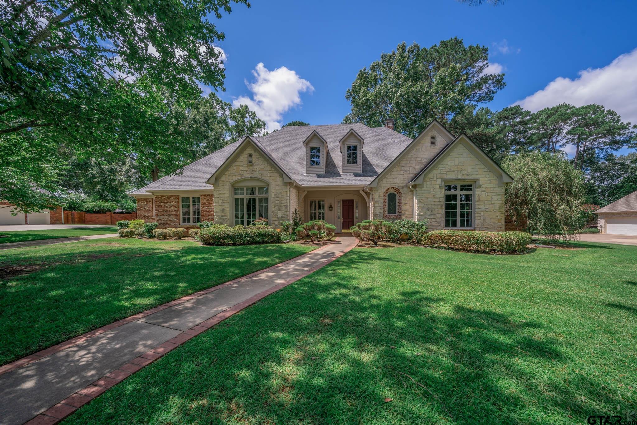 7 Summer Creek Way Longview, TX 75604 - Photo 2 of 48 a view of a house with a big yard potted plants and large tree