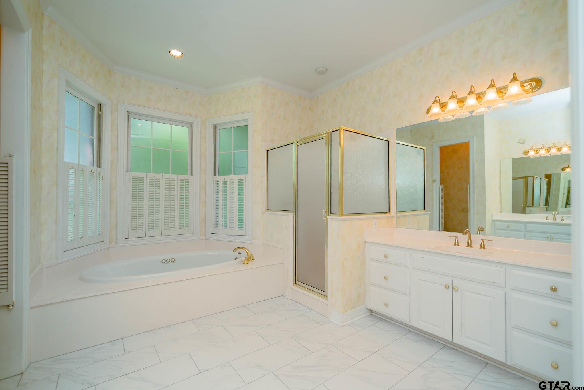 7 Summer Creek Way Longview, TX 75604 - Photo 24 of 48 a spacious bathroom with a tub sink and mirror