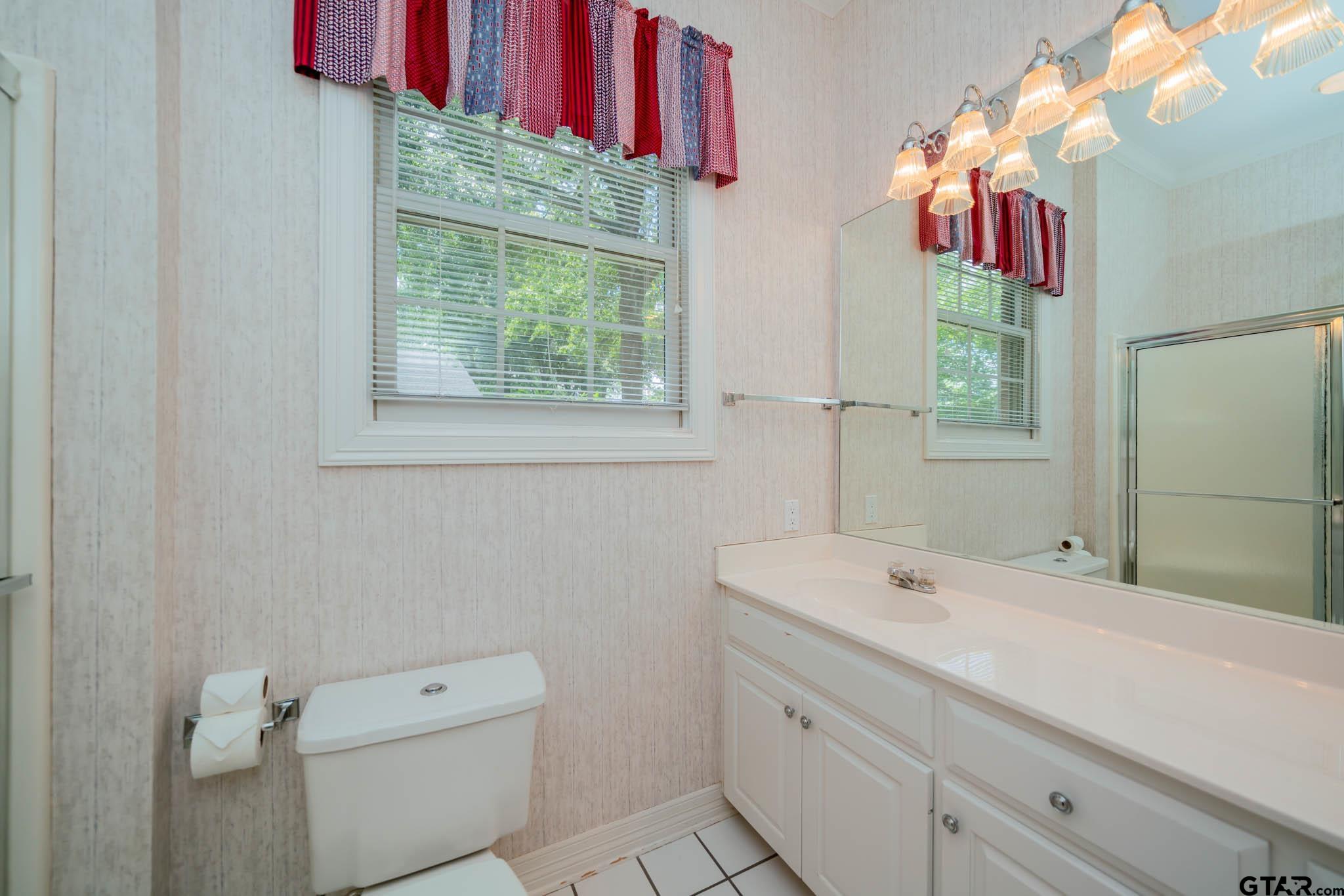 7 Summer Creek Way Longview, TX 75604 - Photo 27 of 48 a bathroom with a sink and a mirror