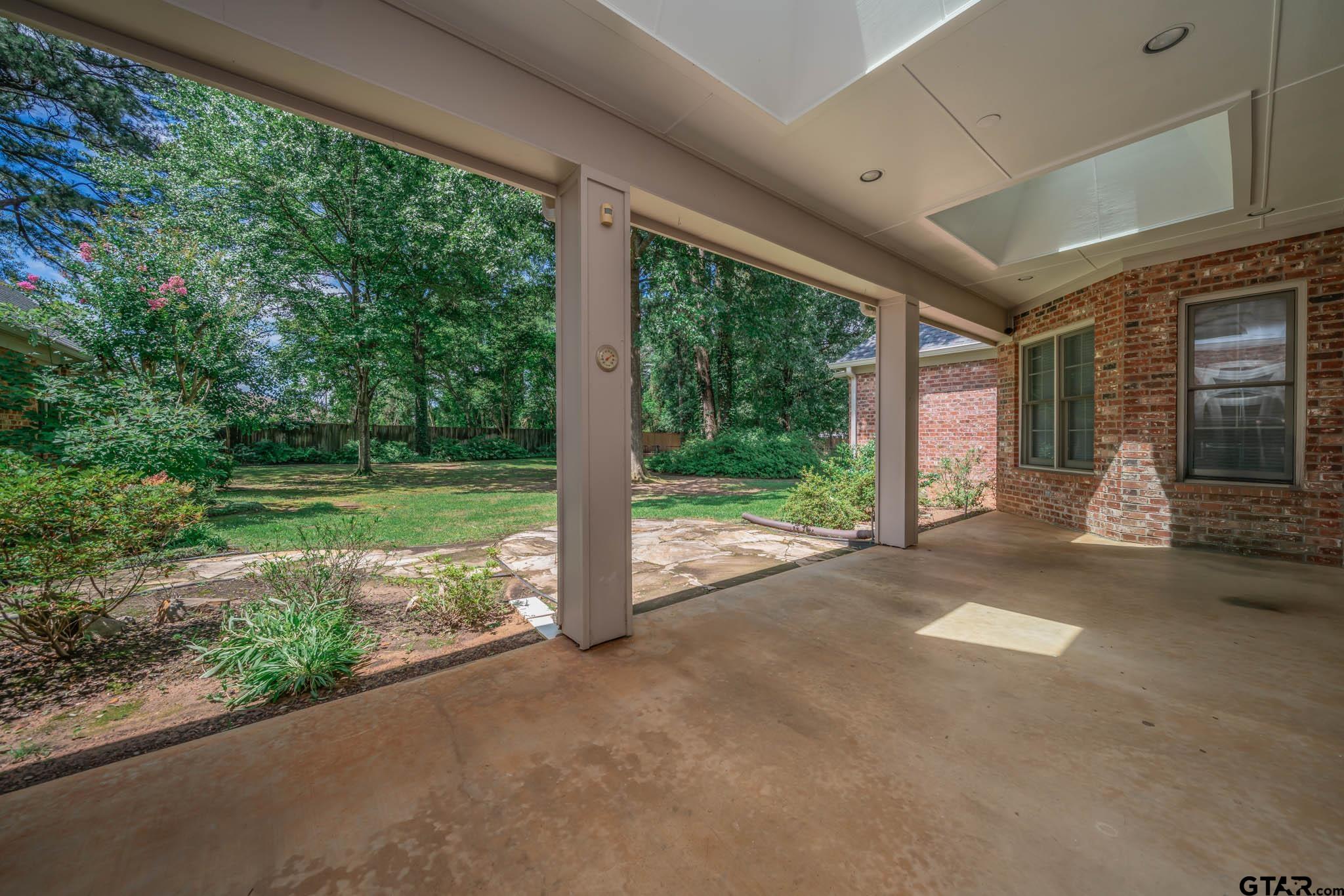 7 Summer Creek Way Longview, TX 75604 - Photo 33 of 48 a view of a house with backyard and porch