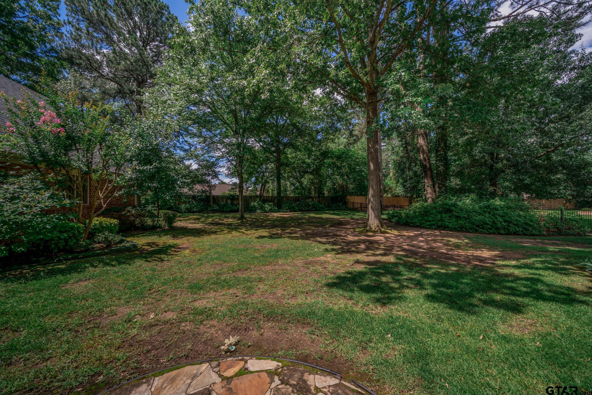 7 Summer Creek Way Longview, TX 75604 - Photo 35 of 48 a backyard of a house with lots of green space
