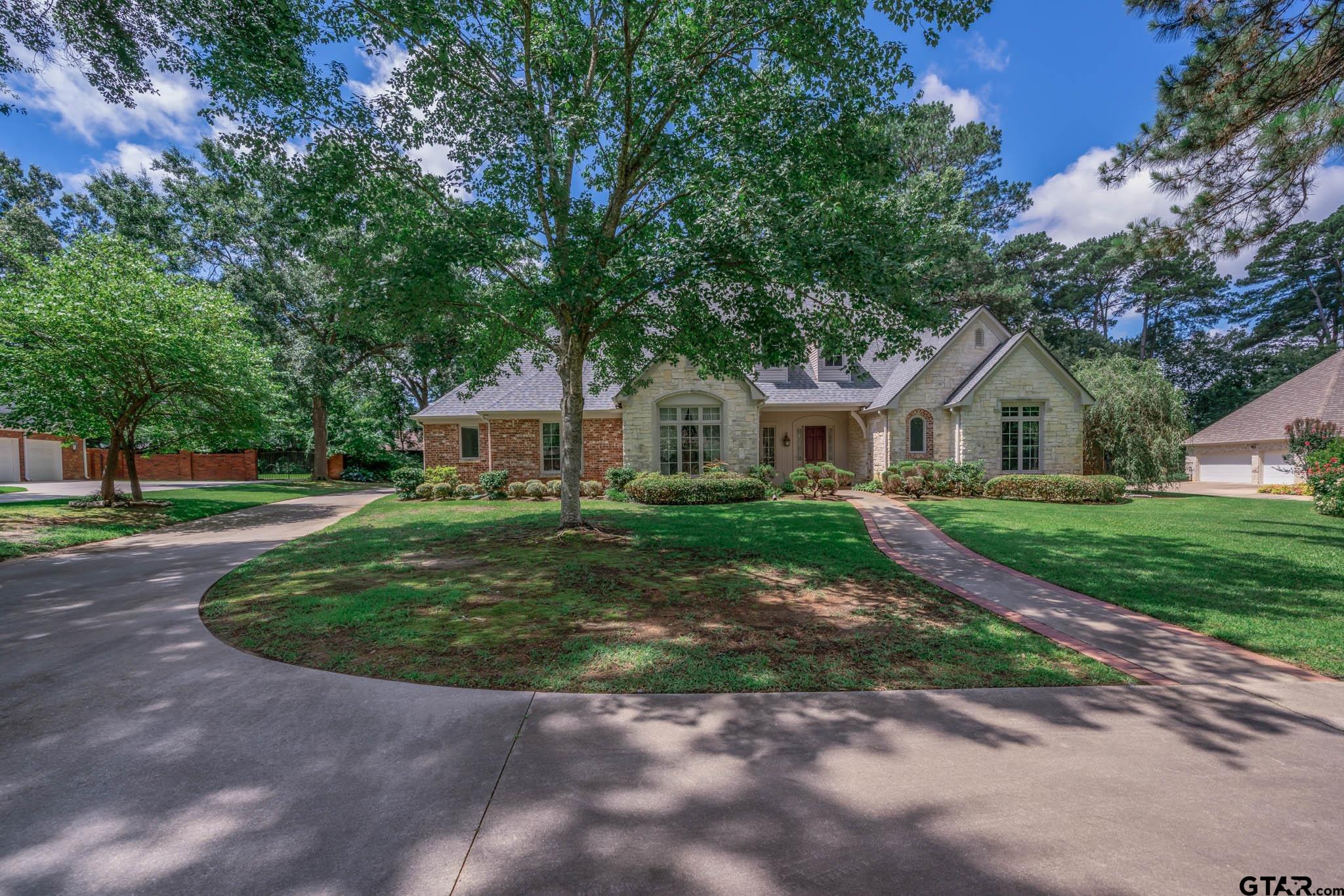 7 Summer Creek Way Longview, TX 75604 - Photo 39 of 48 a front view of a house with a yard and garage