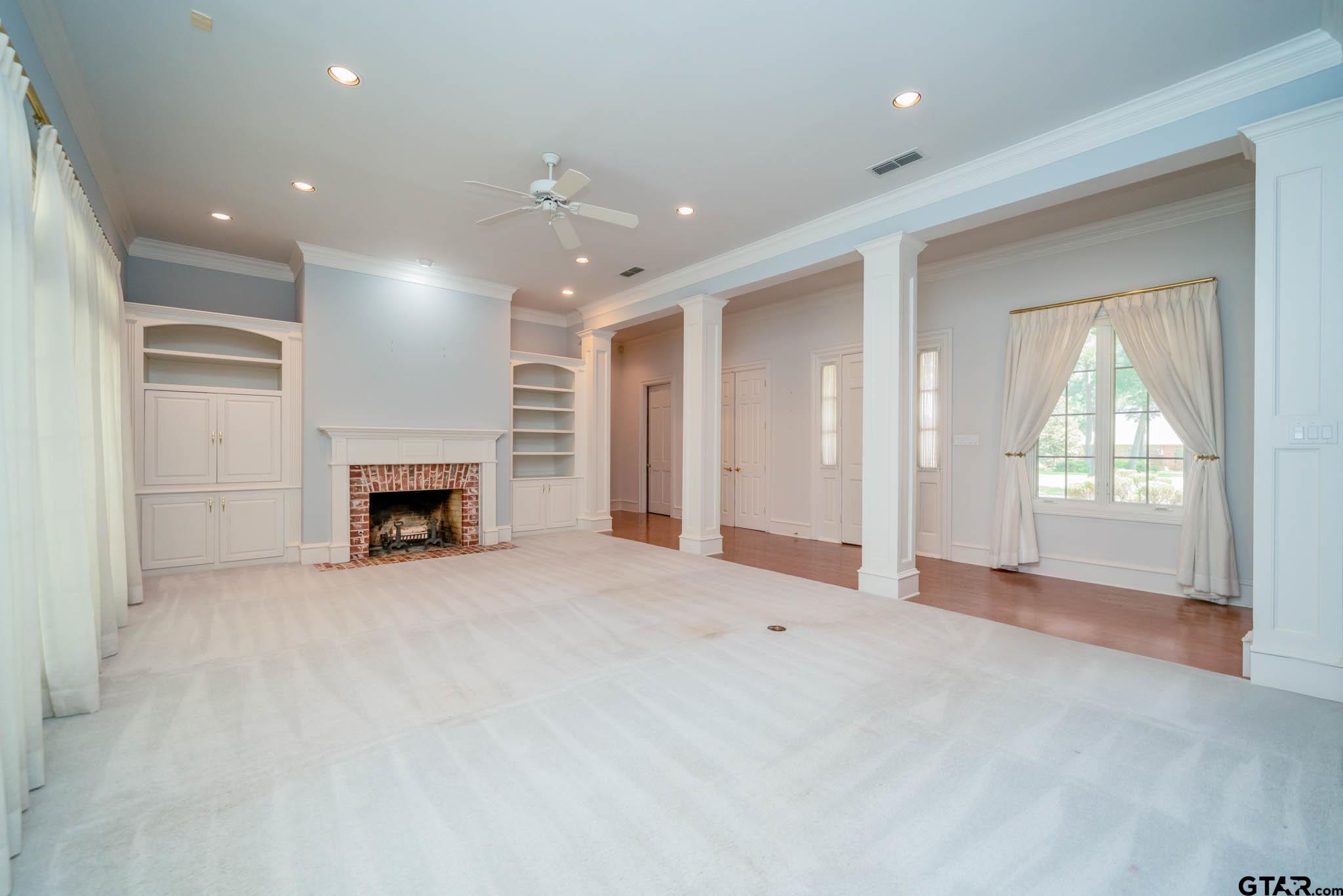 7 Summer Creek Way Longview, TX 75604 - Photo 5 of 48 an empty room with windows and fireplace