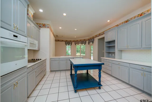 a kitchen with a sink cabinets and window