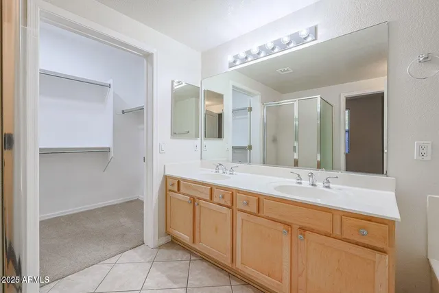 a bathroom with a double vanity sink mirror and