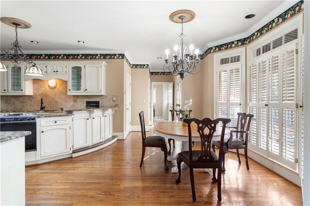 3910 Spalding Bluff Drive Peachtree Corners, GA 30092 - Photo 11 of 35 a view of a dining room with furniture and wooden floor
