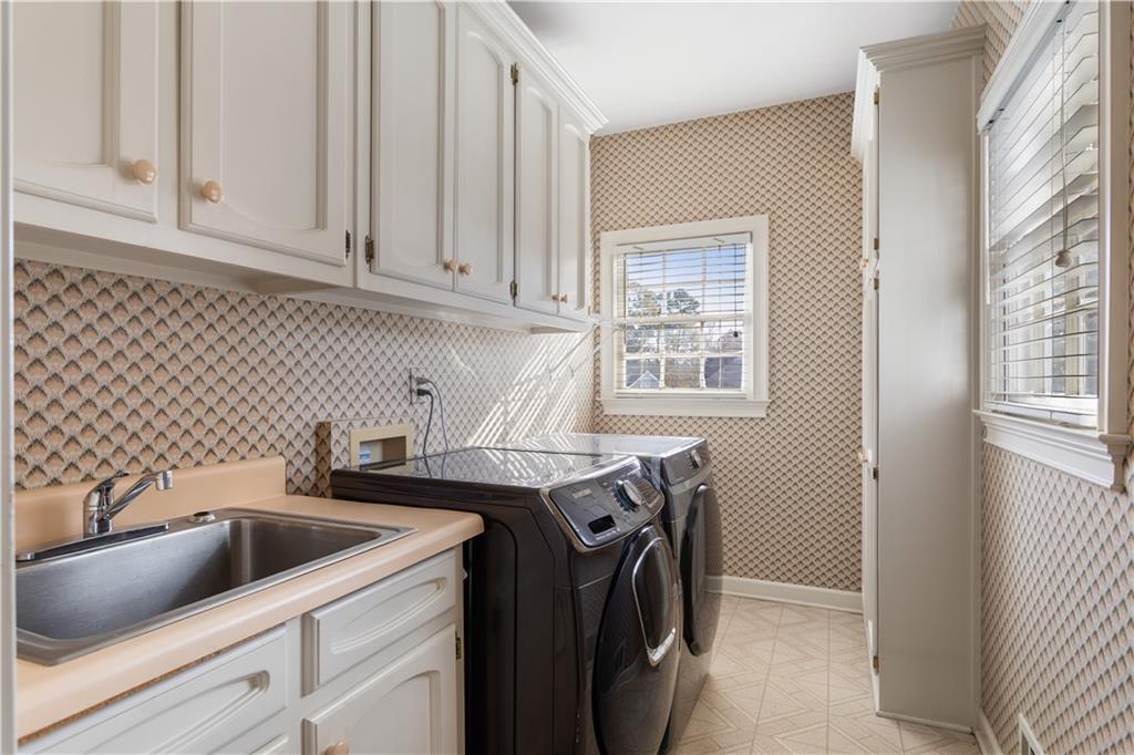 3910 Spalding Bluff Drive Peachtree Corners, GA 30092 - Photo 13 of 35 a utility room with sink dryer and washer