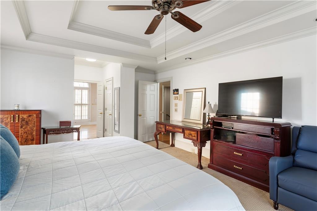 3910 Spalding Bluff Drive Peachtree Corners, GA 30092 - Photo 16 of 35 a bedroom with a bed and a flat screen tv