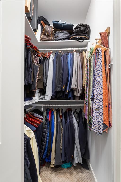 3910 Spalding Bluff Drive Peachtree Corners, GA 30092 - Photo 19 of 35 a view of walk in closet with clothes and shoes