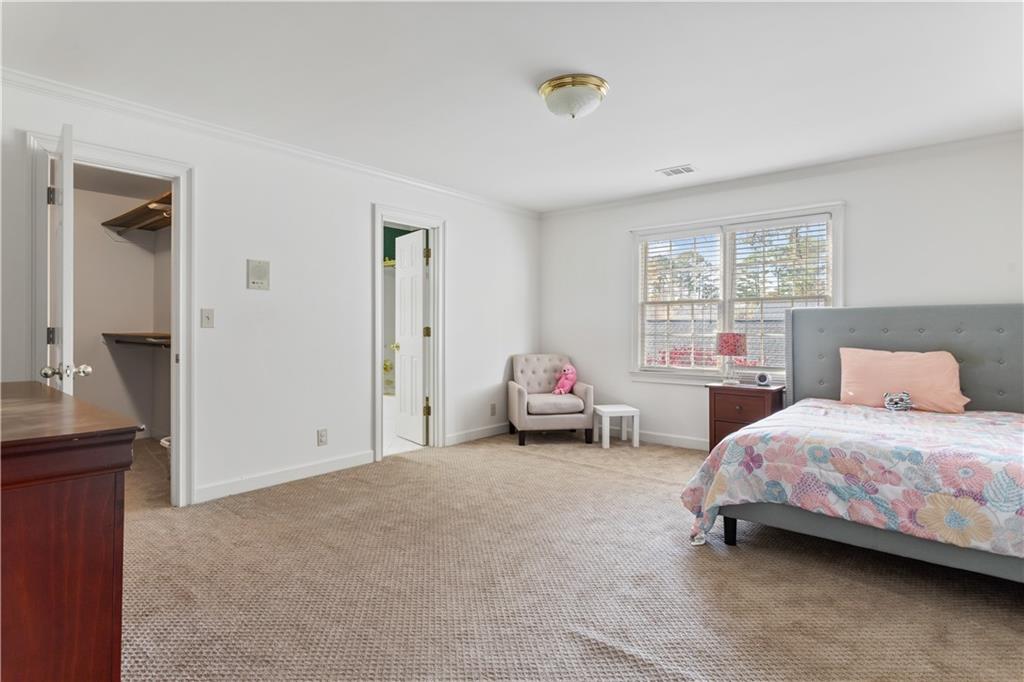 3910 Spalding Bluff Drive Peachtree Corners, GA 30092 - Photo 23 of 35 a bedroom with a bed and a window