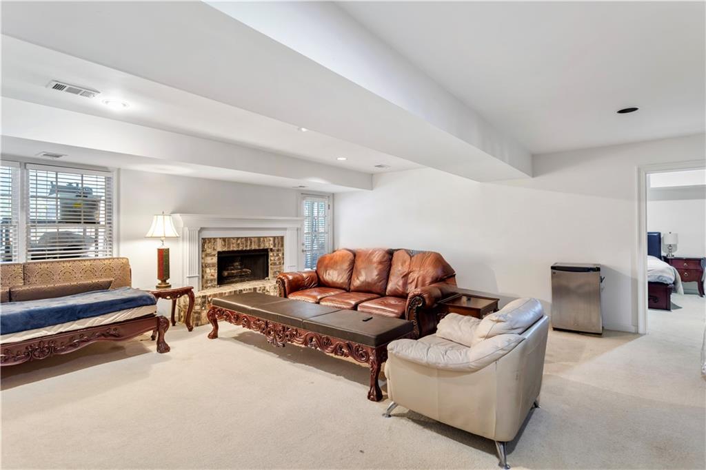 3910 Spalding Bluff Drive Peachtree Corners, GA 30092 - Photo 27 of 35 a living room with furniture and a fireplace
