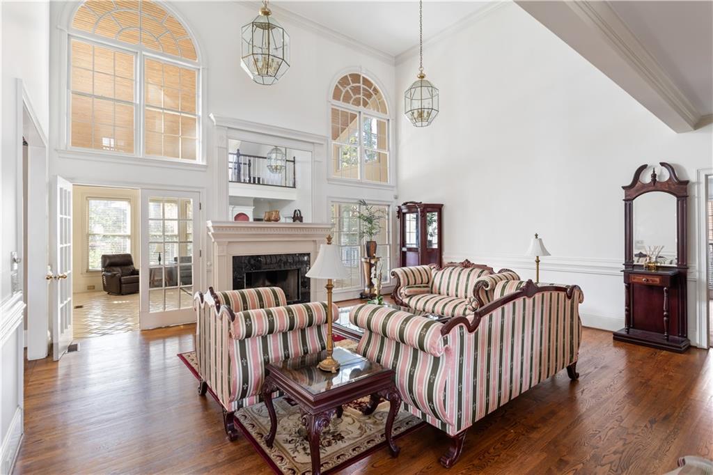 3910 Spalding Bluff Drive Peachtree Corners, GA 30092 - Photo 3 of 35 a living room with furniture a fireplace and wooden floor