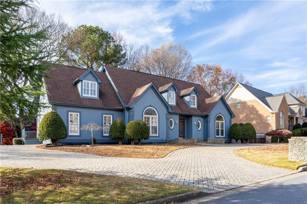 3910 Spalding Bluff Drive Peachtree Corners, GA 30092 - Photo 32 of 35 a front view of a house with a yard and garage