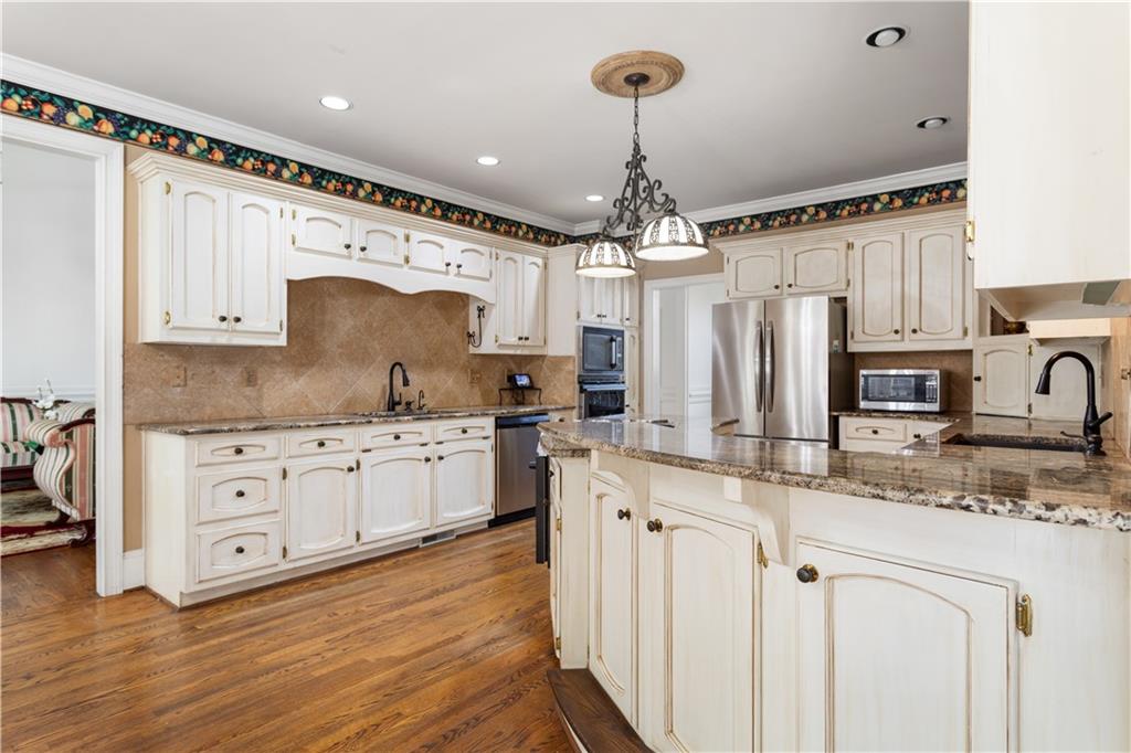 3910 Spalding Bluff Drive Peachtree Corners, GA 30092 - Photo 10 of 35 a kitchen with stainless steel appliances granite countertop a stove refrigerator and cabinets