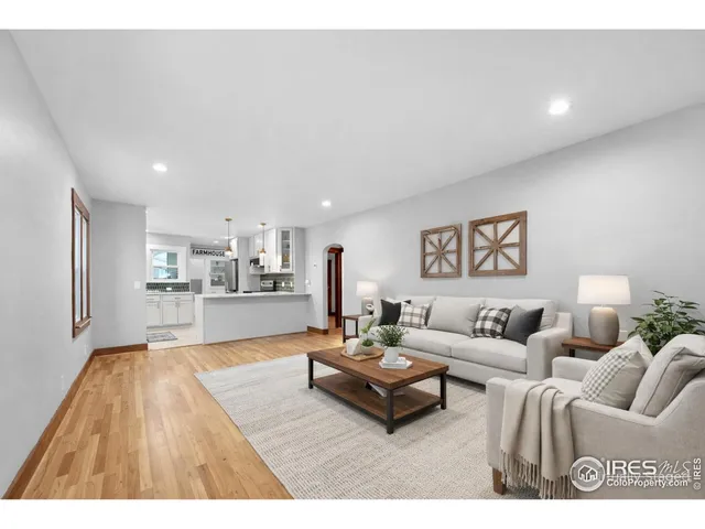 a living room with furniture and view of kitchen