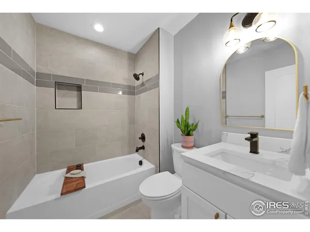 a bathroom with a sink a mirror and a potted plant