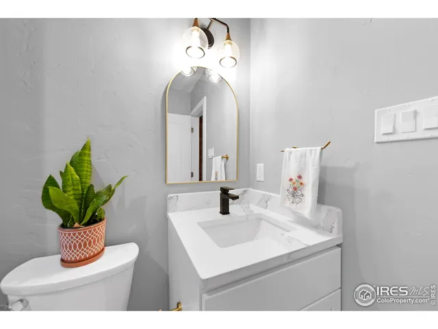 a kitchen with white cabinets and appliances