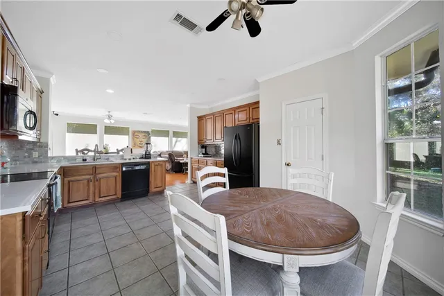 a kitchen with a stove a refrigerator and a sink