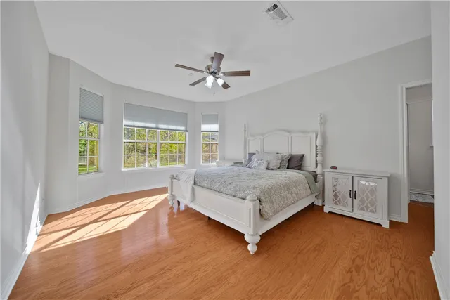 a bedroom with a bed dresser and a window