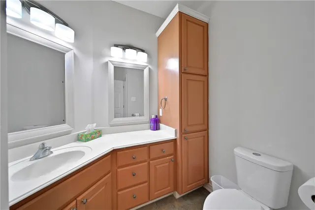 a bathroom with a toilet sink and mirror