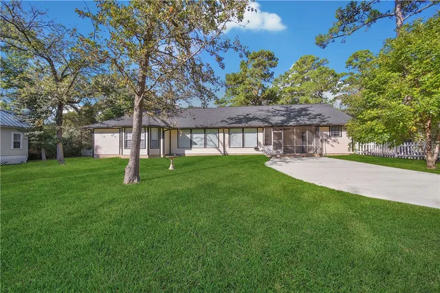 a view of a house with a backyard porch and sitting area
