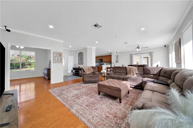 a living room with lots of furniture and a flat screen tv