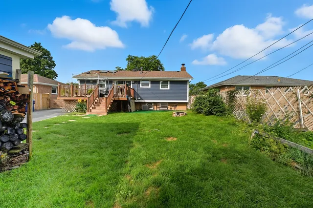 a view of a roof deck with table and chairs with wooden floor and fence