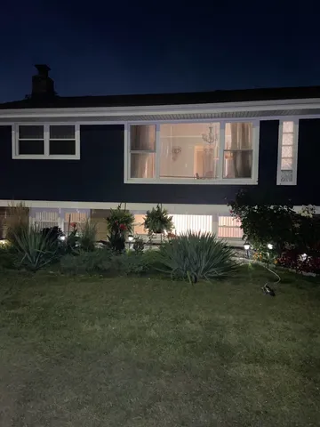 a front view of a house with a garden