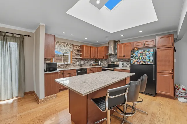 a kitchen with a table chairs refrigerator and microwave