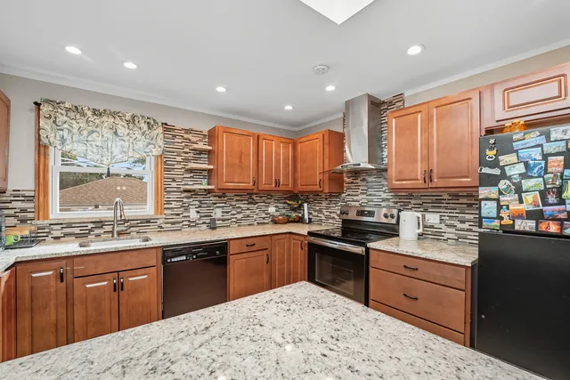 a kitchen with stainless steel appliances granite countertop a sink stove cabinets and wooden floor