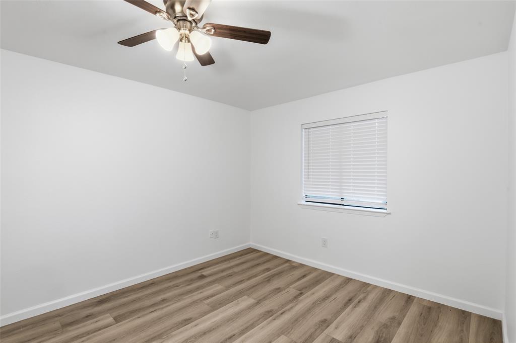 6646 East Lovers Lane, Unit 1201 Dallas, TX 75214 - Photo 12 of 24 an empty room with a window and a fan