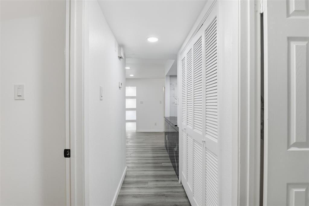 6646 East Lovers Lane, Unit 1201 Dallas, TX 75214 - Photo 15 of 24 a view of a hallway with wooden floor