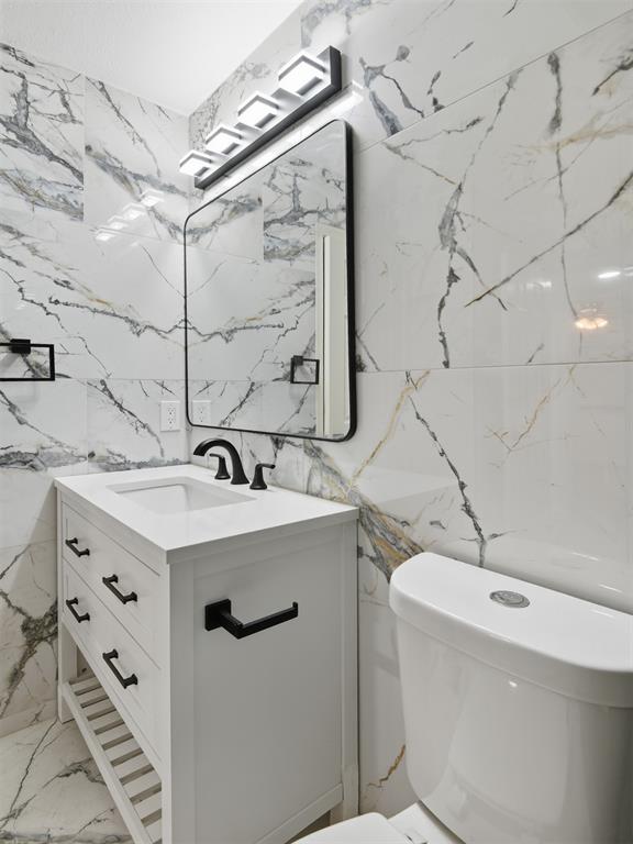 6646 East Lovers Lane, Unit 1201 Dallas, TX 75214 - Photo 17 of 24 a bathroom with a sink vanity granite toilet and shower