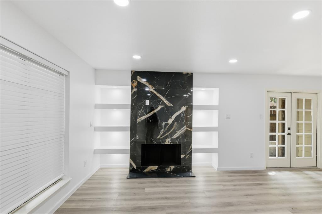 6646 East Lovers Lane, Unit 1201 Dallas, TX 75214 - Photo 4 of 24 a view of an empty room with wooden floor and windows