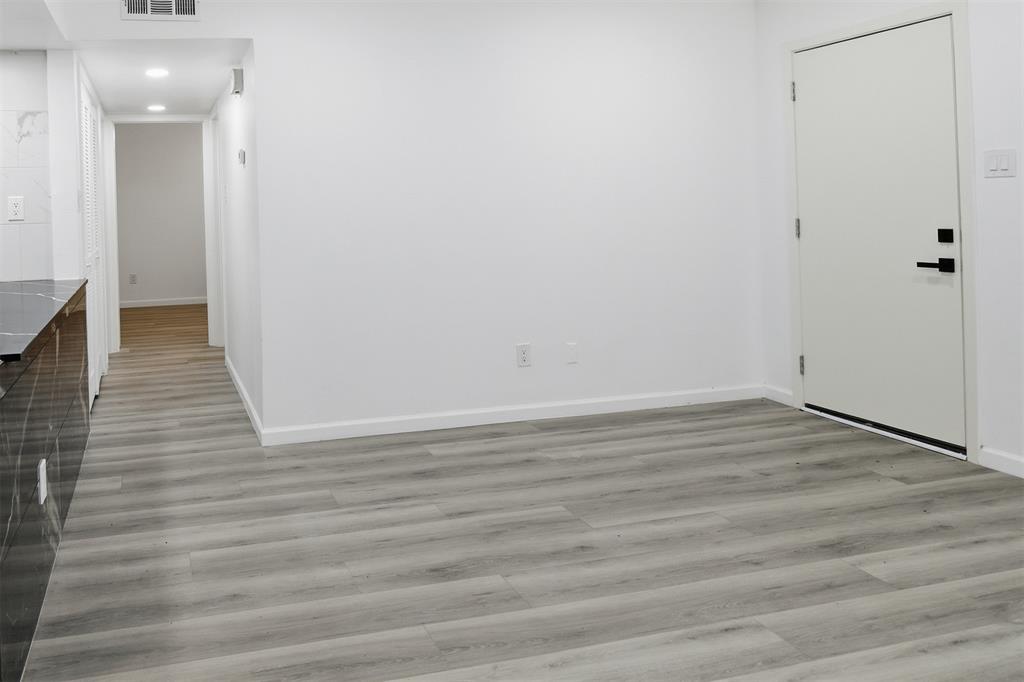 6646 East Lovers Lane, Unit 1201 Dallas, TX 75214 - Photo 5 of 24 a view of a hallway with wooden floor