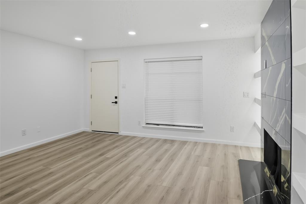 6646 East Lovers Lane, Unit 1201 Dallas, TX 75214 - Photo 6 of 24 a view of an empty room with wooden floor and a window
