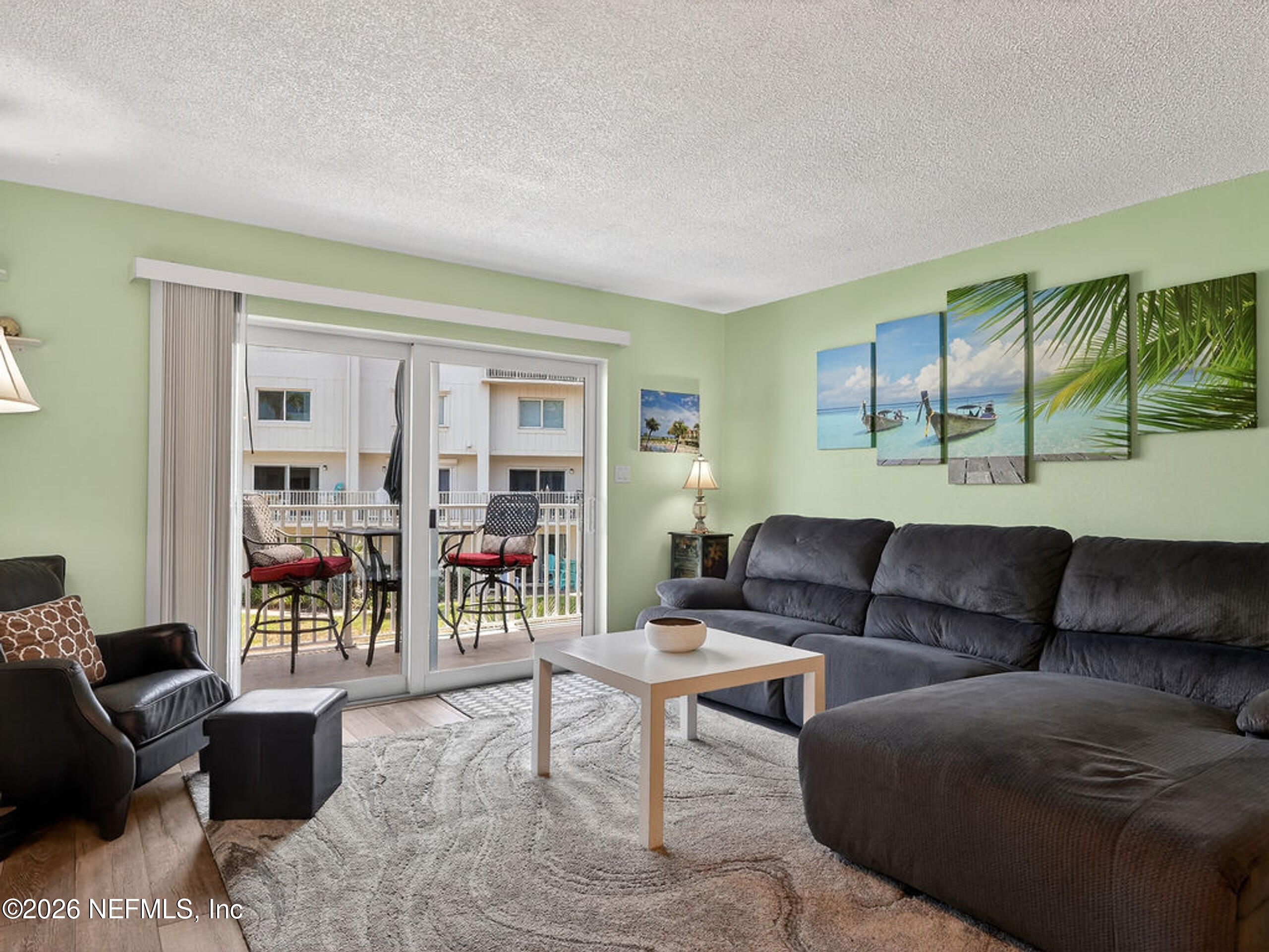 1 Ocean Trace Road, Unit 230 St. Augustine Beach, FL 32080 - Photo 11 of 50 a living room with furniture and a wooden floor