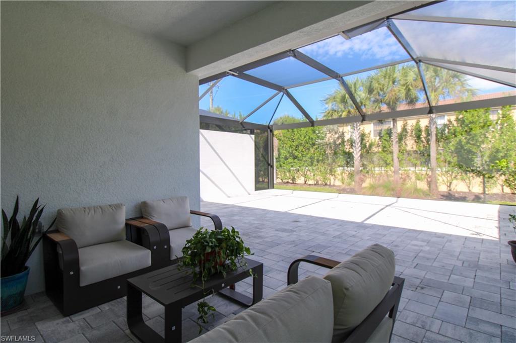 14803 Loggerhead Drive Naples, FL 34120 - Photo 12 of 50 a living room with furniture and a window