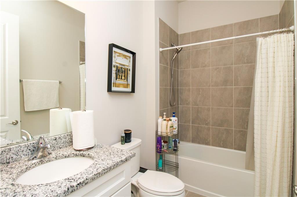 14803 Loggerhead Drive Naples, FL 34120 - Photo 15 of 50 a bathroom with a granite countertop toilet sink and bathtub