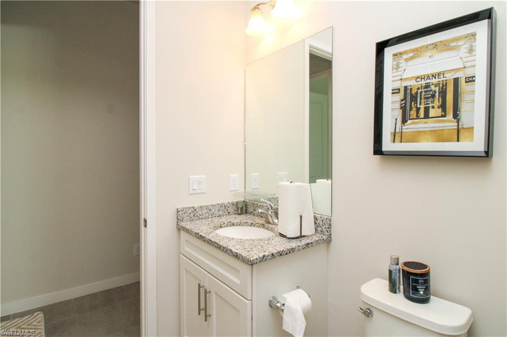 14803 Loggerhead Drive Naples, FL 34120 - Photo 16 of 50 a bathroom with a sink and a mirror