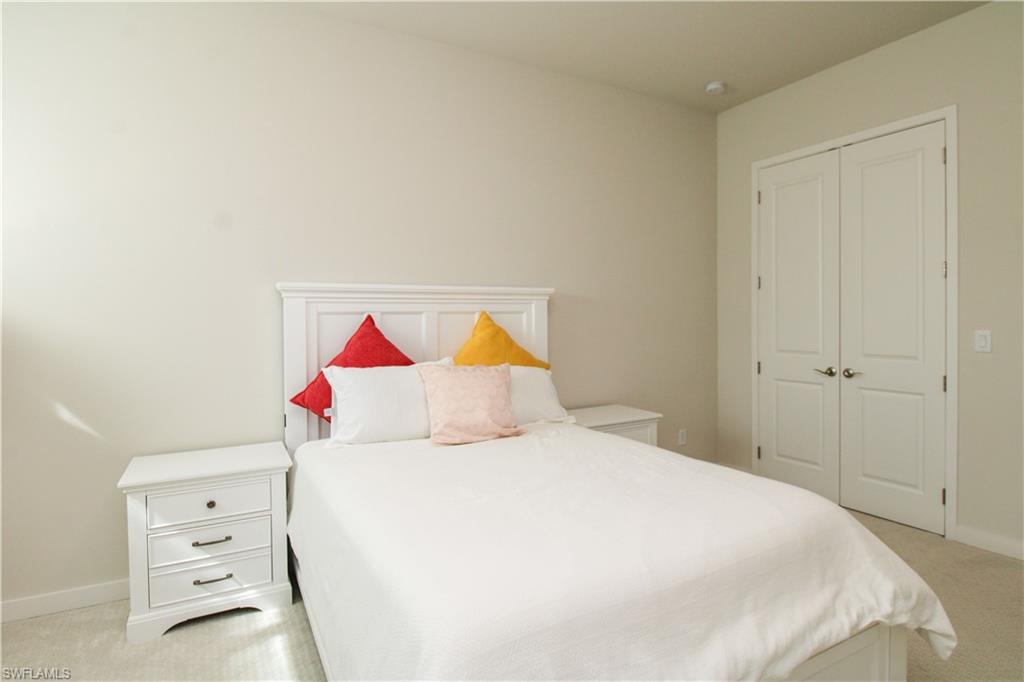 14803 Loggerhead Drive Naples, FL 34120 - Photo 18 of 50 a bedroom with a bed and a dresser in it