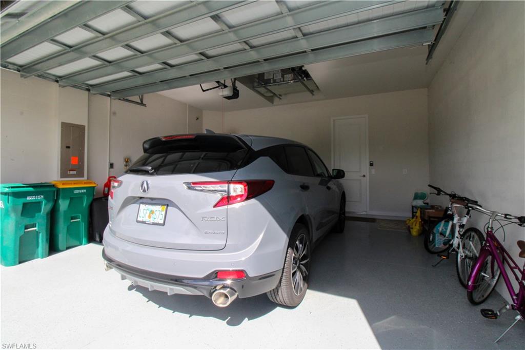 14803 Loggerhead Drive Naples, FL 34120 - Photo 2 of 50 a car and bike parked in a garage