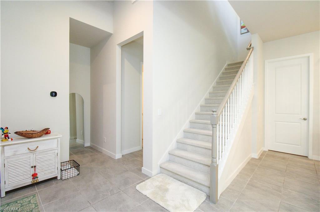 14803 Loggerhead Drive Naples, FL 34120 - Photo 21 of 50 a view of hallway with stairs and furniture