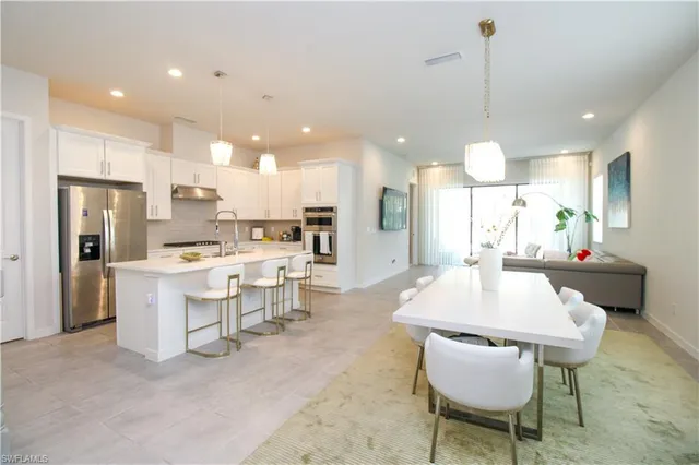 a large kitchen with a table and chairs