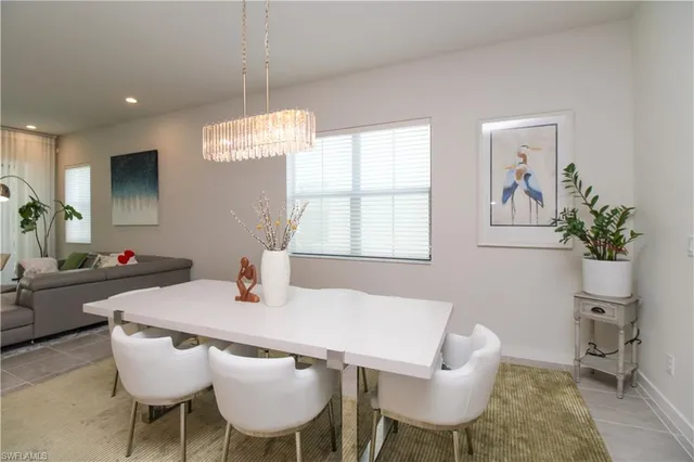 a view of a dining room with furniture and a chandelier