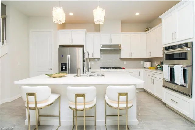 a kitchen with kitchen island cabinets and refrigerator
